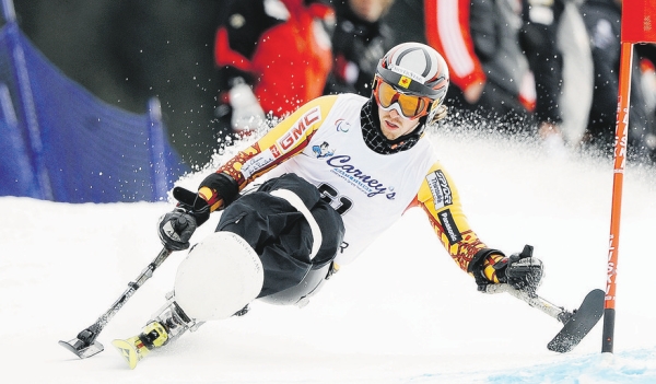 Photograph by: Mark Van Manen, Vancouver Sun, Vancouver Sun;Canada's Josh Dueck 51, goes hard around the gate in a men's giant slalom race on Whistler Mountain at the site of the 2010 Paralympic Winter Games.  