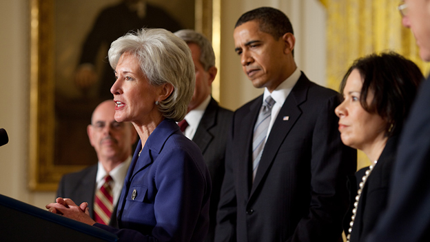 Photo credit: Peter Souza, White House; Description: Kathleen Sebelius speaking after her official nomination as Secretary of Health and Human Services. President Barack Obama is standing behind Sebelius.