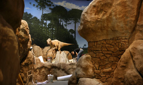Photograph: Melanie Stetson Freeman/Christian Science Monitor/Getty; Description:  A worker puts the final touches to the 'enclosure' for an animatronic dinosaur at the Creation Museum in Petersburg, Kentucky.