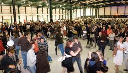 Photo credit: C. MARCELLONI/CERN; description: Like a giant commune, members of the ATLAS collaboration work, eat and party together.