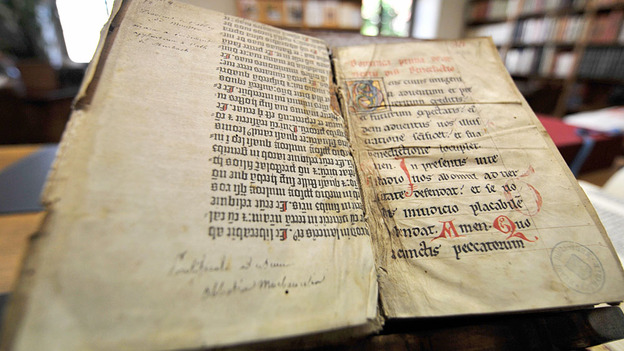 Photo Credit:  Johanna Leguerre/AFP/Getty Images; Description: Pages of the Gutenberg Bible in Colmar, France. Religious historian Philip Jenkins says scriptures from the Bible are more violent than those from the Quran.