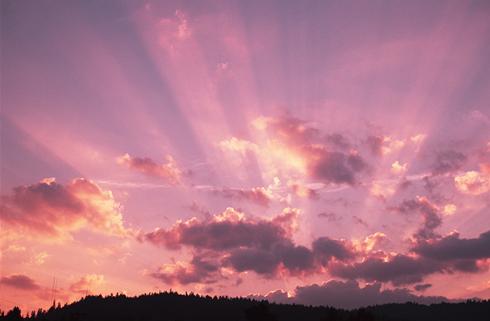 photo:  A colorful sky with sunbeams breaking through the clouds.    credit: Photodisc