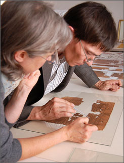 photo:  Florence Darbre observes researcher Gregor Wurst's careful inspection of the ancient codex.  credit:  Cheryl R. Zook, NGT