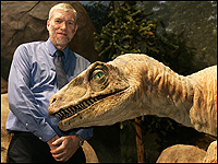Photo Credit:  Jeff Haynes/AFP/Getty Images Ken Ham poses with a mechanical Utahraptor at The Creation Museum.