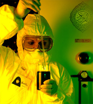 photo:  person in biohazard suit and goggles using a pipette to remove liquid from a beaker