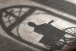 Credit: Suzy Parker, USA Today; Description: graphic of man in wheelchair in church portal