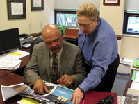 Assistant district attorneys Drew Robinson and Cynthia Lecroy-Schemel look over crime scene photos from Bradley Waldroup's home the night he killed his wife's friend. The team says it's the bloodiest crime scene they've ever seen.(Barbara Bradley Hagerty)