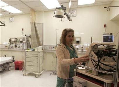 A nurse checks monitoring equipment in a file photo. End-of-life issues top the list of ethical dilemmas hospitals face as medical progress enables doctors to extend an endangered life to the hard-to-determine point where they may actually only be dragging out death. Credit: Reuters/Lee Celano