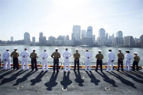 Photo Credit: Reuters/Lucas Jackson/Files; Description: U.S. Marine Corps and Navy personnel salute at the rails of the USS Iwo Jima as the amphibious assault ship passes Ground Zero in New York Harbor for Fleet Week May 26, 2010. 