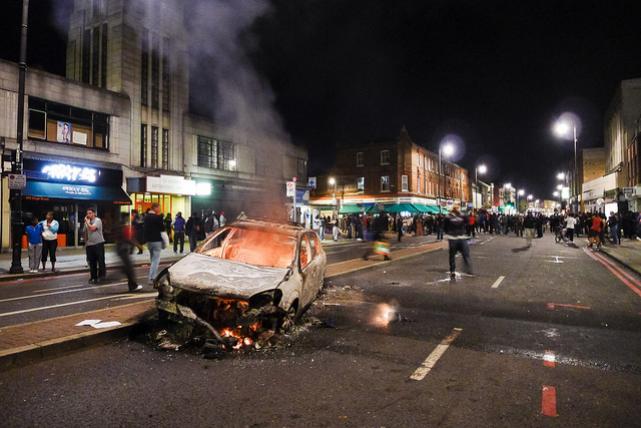 photo: Flickr/Nicobobinus; description: rioters in UK
