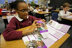 Photo credit: Jim Stipe, CRS; Description: A fourth-grade student at the Shrine of the Sacred Heart School in Baltimore assembles a cardboard bowl used to raise money for Operation Rice Bowl.