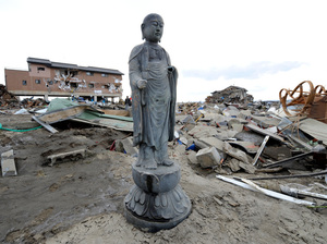 Photo credit: Toru Yamanaka/AFP/Getty Images; Description: A religious statue stands amid the debris left by last Friday's tsunami in Natori, Miyagi prefecture. Many Japanese will turn to Shinto and Buddhist rituals as they cope with the disaster stemming from a powerful earthquake.