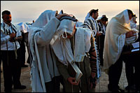 David Silverman/Getty Images As the sun rises over the Sea of Galilee in northern Israel Wednesday, Jews cover themselves and their sons to receive the priestly blessing during the Blessing of the Sun. 