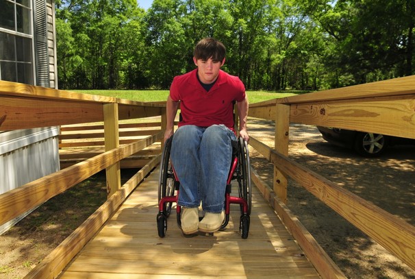 Photo credit: David Bundy / For The Washington Post; Description: imothy J. Atchison, known to friends and family as T.J., wheels up a ramp outside his home in Chatom, Ala. Atchison, 21, who was paralyzed in a car crash in 2010, has identified himself as the volunteer who was treated by researchers with human embryonic stem cells.